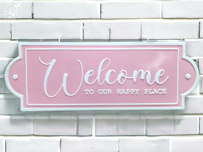 Welcome To Our Happy Place Enamel Wall Sign – Pink  |  Quote Wall Plaques Homewares Quote Wall Plaques